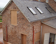 Sandblasting stonework clean during house renovation.