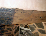 Stripping and cleaning a wooden beam.