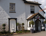 Front of hotel before sandblasting begins to expose stone wall.