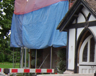 Front of hotel during sandblasting: Stone walls begin to become exposed.