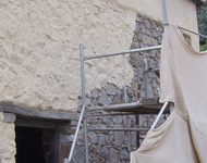 Exterior stone wall being exposed by sandblasting.