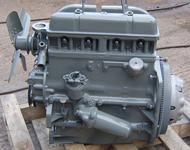 Vintage tractor engine before and after sandblasting and refinishing.