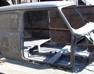 Transit van being cleaned by sandblasting.